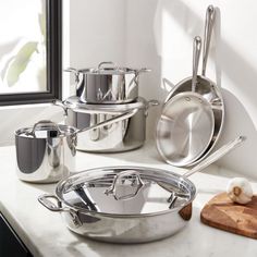 True kitchen essentials, this cookware set from All-Clad features everything you need to effortlessly prepare home-cooked meals. Stainless steel, three-ply construction with thick-gauge aluminum cores heat up fast, evenly distributing heat for flawless results. Stainless steel interiors with a starburst finish offer natural stick resistance and a surface that won't react with food. Set includes 8 and 10 fry pans; 2-qt. sauce pan with lid; 3-qt. casserole with lid; 3-qt. saute pan with lid; and 8